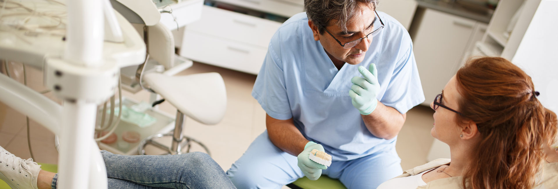 Dentist in the Dental Clinic Talking to a Female Patient