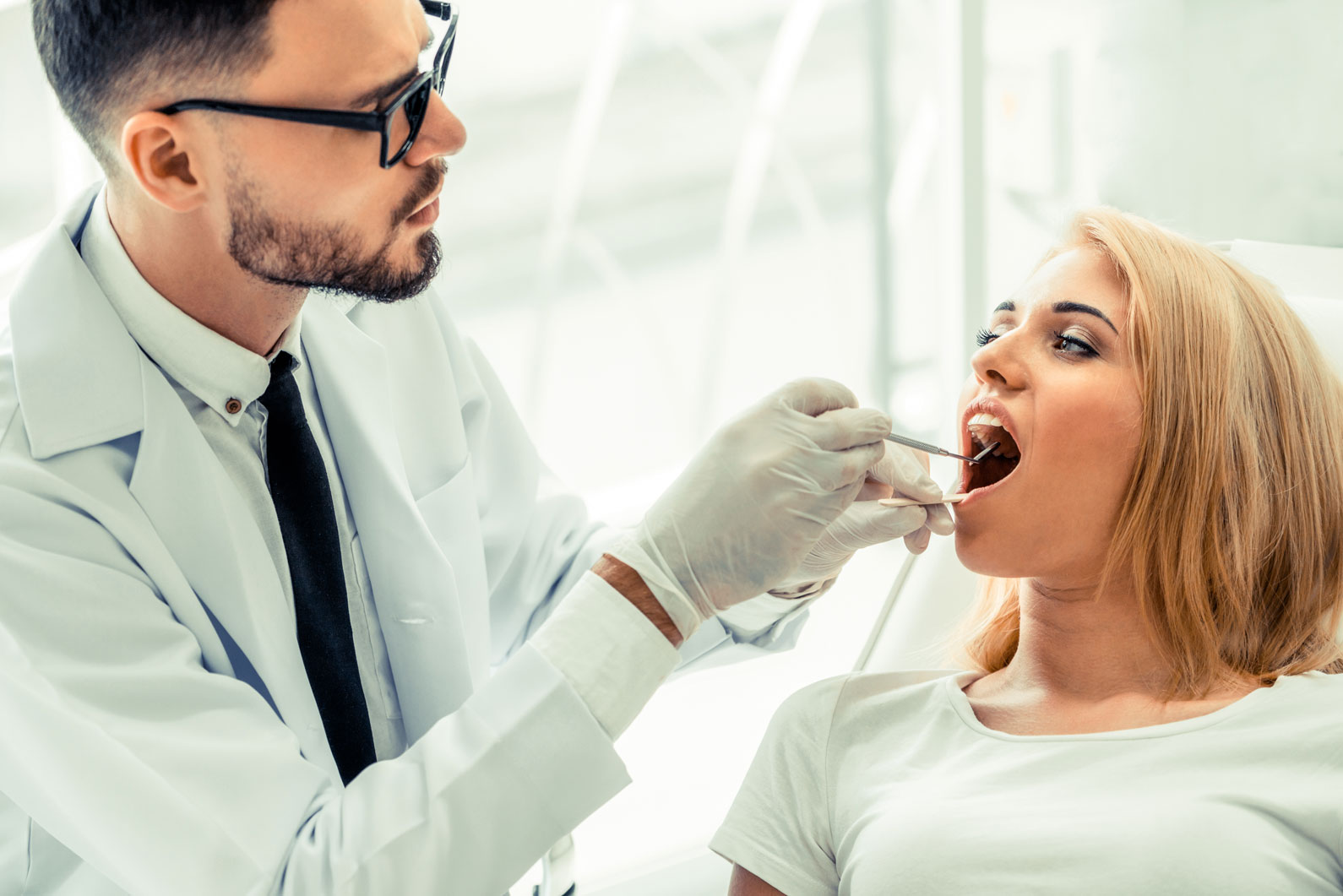 Dentist Examining the Teeth of a Patient